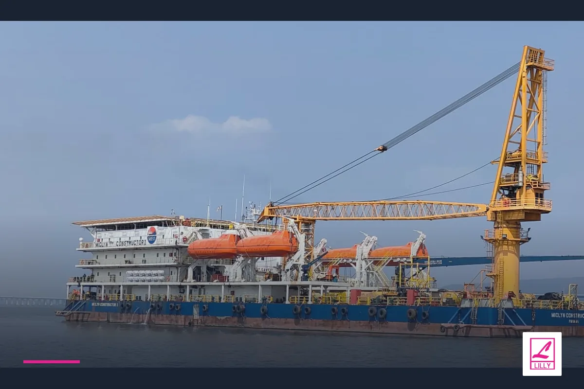 A crane vessel with yellow lifting equipment and orange lifeboats is seen broadside, with a navy and magenta Lilly Maritime treatment.