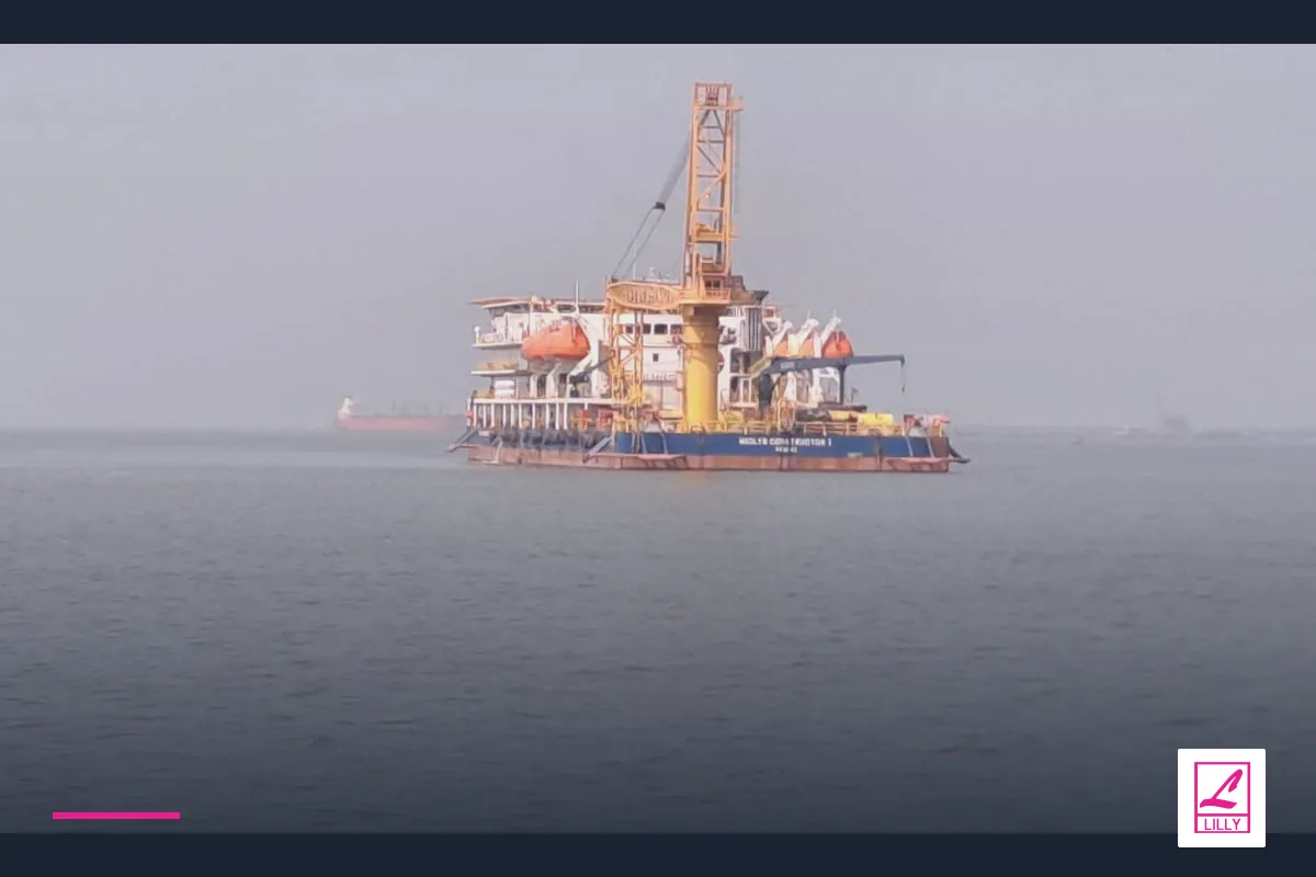 A distant crane vessel sits on hazy open water, with a navy and magenta Lilly Maritime treatment.